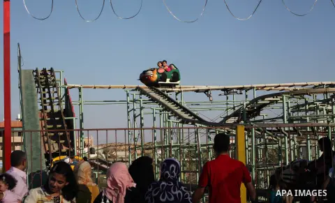 Palestinians enjoy a ride in an amusement park on the third day of Eid al-Fitr, marking the end of Islam's fasting holy month of Ramadan, in Gaza City on August 21, 2012. Photo by Ashraf Amra