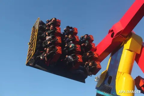 Palestinians enjoy a ride in an amusement park on the third day of Eid al-Fitr, marking the end of Islam's fasting holy month of Ramadan, in Gaza City on August 21, 2012. Photo by Ashraf Amra