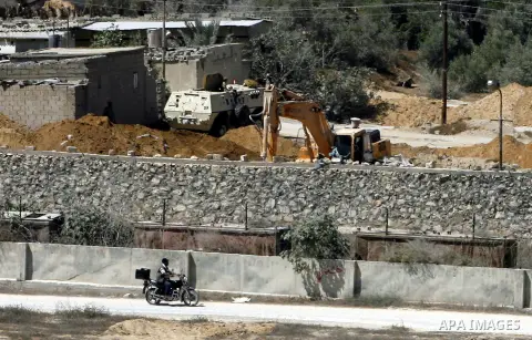 A view of soldiers from the Egyptian army destroying the infrastructure of smuggling tunnels along the Egypt-Gaza border is seen from Rafah, southern Gaza Strip, on August 22, 2012, as sources in Cairo suggested some of...