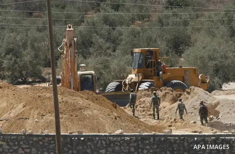 A view of soldiers from the Egyptian army destroying the infrastructure of smuggling tunnels along the Egypt-Gaza border is seen from Rafah, southern Gaza Strip, on August 22, 2012, as sources in Cairo suggested some of...