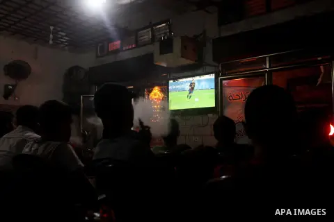 Palestinian youths watch a soccer match for FC Barcelona team against Real Madrid team during a Spanish Supercup at cafe in Deir al-Balah central Gaza Strip, on Aug 23, 2012. Photo by Ashraf Amra