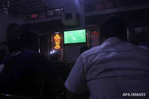 Palestinian youths watch a soccer match for FC Barcelona team against Real Madrid team during a Spanish Supercup at cafe in Deir al-Balah central Gaza Strip, on Aug 23, 2012. Photo by Ashraf Amra