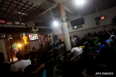 Palestinian youths watch a soccer match for FC Barcelona team against Real Madrid team during a Spanish Supercup at cafe in Deir al-Balah central Gaza Strip, on Aug 23, 2012. Photo by Ashraf Amra