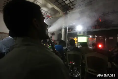 Palestinian youths watch a soccer match for FC Barcelona team against Real Madrid team during a Spanish Supercup at cafe in Deir al-Balah central Gaza Strip, on Aug 23, 2012. Photo by Ashraf Amra
