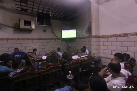 Palestinian youths watch a soccer match for FC Barcelona team against Real Madrid team during a Spanish Supercup at cafe in Deir al-Balah central Gaza Strip, on Aug 23, 2012. Photo by Ashraf Amra