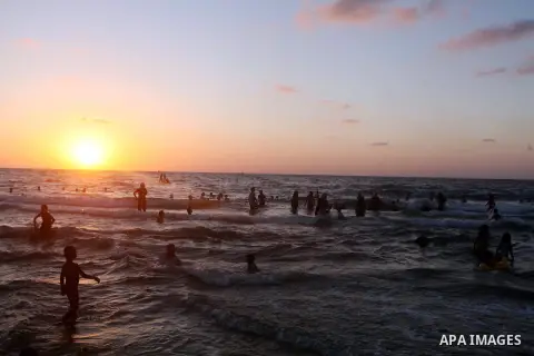Palestinians enjoy swimming in the sea at Gaza beach during Friday holiday in Gaza city, Aug 24, 2012. Gazans escape to the beach and out from their homes during heat wave and power outages. Photo by Ashraf Amra