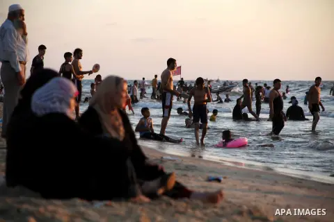 Palestinians enjoy swimming in the sea at Gaza beach during Friday holiday in Gaza city, Aug 24, 2012. Gazans escape to the beach and out from their homes during heat wave and power outages. Photo by Ashraf Amra
