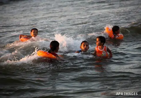 Palestinian children enjoy swimming in the sea at Gaza beach during Friday holiday in Gaza city, Aug 24, 2012. Gazans escape to the beach and out from their homes during heat wave and power outages. Photo by Ashraf Amra