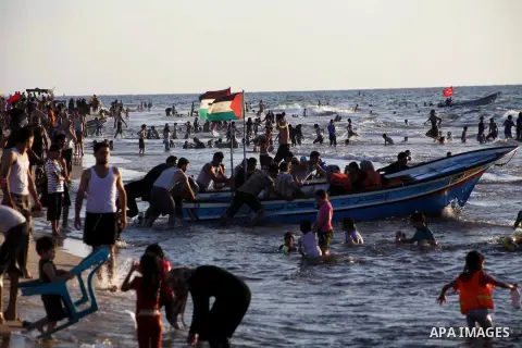 Palestinians enjoy swimming in the sea at Gaza beach during Friday holiday in Gaza city, Aug 24, 2012. Gazans escape to the beach and out from their homes during heat wave and power outages. Photo by Ashraf Amra