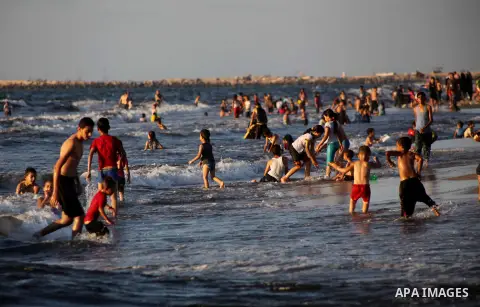 Palestinians enjoy swimming in the sea at Gaza beach during Friday holiday in Gaza city, Aug 24, 2012. Gazans escape to the beach and out from their homes during heat wave and power outages. Photo by Ashraf Amra