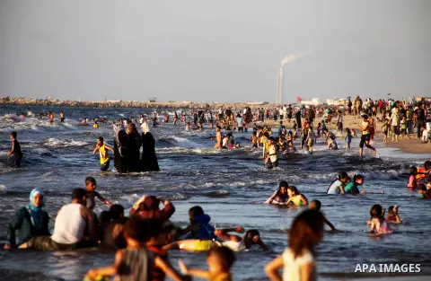 Palestinians enjoy swimming in the sea at Gaza beach during Friday holiday in Gaza city, Aug 24, 2012. Gazans escape to the beach and out from their homes during heat wave and power outages. Photo by Ashraf Amra