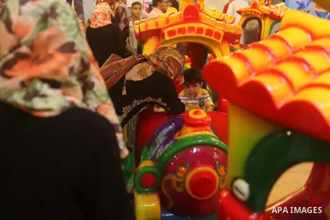 Palestinians children enjoy a ride in an amusement park, during School holidays in Gaza City, Aug. 25, 2012. Photo by Majdi Fathi