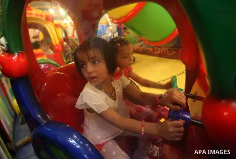 Palestinians children enjoy a ride in an amusement park, during School holidays in Gaza City, Aug. 25, 2012. Photo by Majdi Fathi