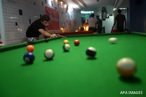 Palestinians youth enjoy billiard Games , during university holidays in Gaza City, Aug. 25, 2012. Photo by Majdi Fathi