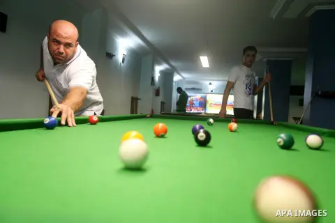 Palestinians youth enjoy billiard Games, during university holidays in Gaza City, Aug. 25, 2012. Photo by Majdi Fathi