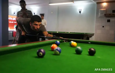 Palestinians youth enjoy billiard Games, during university holidays in Gaza City, Aug. 25, 2012. Photo by Majdi Fathi