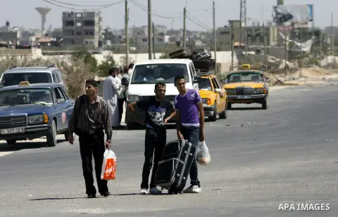 Palestinians load their luggage outside a station at the Rafah border crossing in the southern Gaza Strip before travelling to Egypt on August 25, 2012. Egypt allowed some Palestinians to enter its territory from Gaza ....