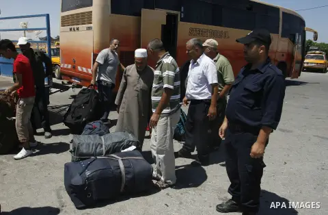 Palestinians load their luggage outside a station at the Rafah border crossing in the southern Gaza Strip before travelling to Egypt on August 25, 2012. Egypt allowed some Palestinians to enter its territory from Gaza ....