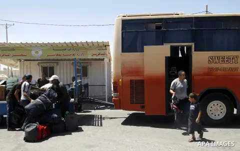 Palestinians load their luggage outside a station at the Rafah border crossing in the southern Gaza Strip before travelling to Egypt on August 25, 2012. Egypt allowed some Palestinians to enter its territory from Gaza ....
