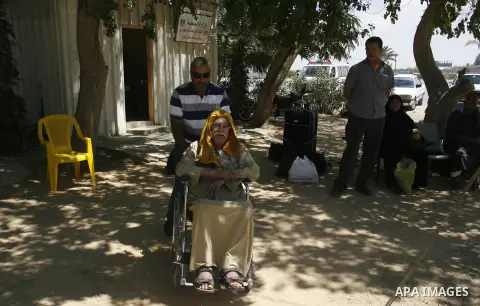 Palestinians wait outside a station at the Rafah border crossing in the southern Gaza Strip before travelling to Egypt on August 25, 2012. Egypt allowed some Palestinians to enter its territory from Gaza. Photo by Eyad A...