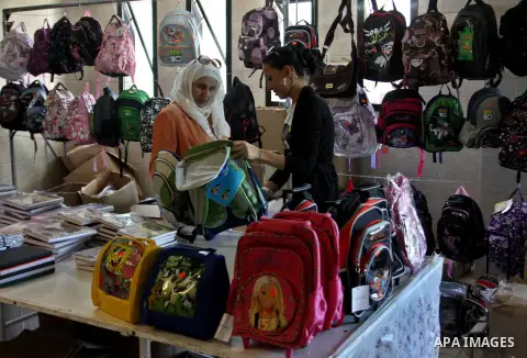 Palestinians participate in the opening of an exhibition to stationery schools in the West Bank city of Nablus on Aug. 26, 2012 . Photo by Nedal Eshtayah