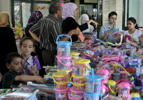 Palestinians participate in the opening of an exhibition to stationery schools in the West Bank city of Nablus on Aug. 26, 2012 . Photo by Nedal Eshtayah