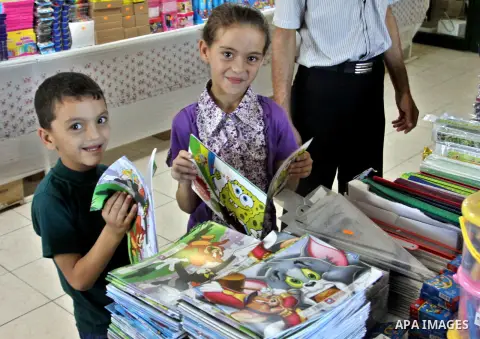 Palestinians participate in the opening of an exhibition to stationery schools in the West Bank city of Nablus on Aug. 26, 2012 . Photo by Nedal Eshtayah