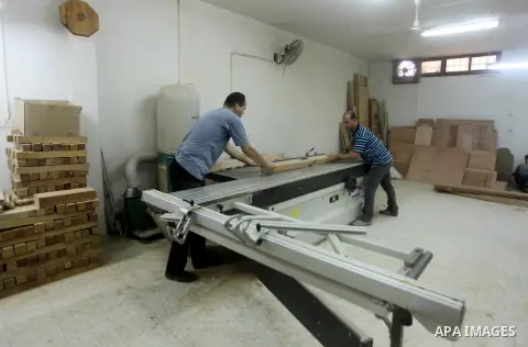 Deaf Palestinian men work on joinery at Atfaluna Society for Deaf Children in Gaza City, on Aug. 26, 2012. The society provides services for about 15,000 deaf youth on education, training programs and income generating p...