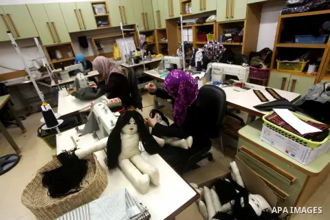 Deaf Palestinian women work on embroidery at Atfaluna Society for Deaf Children in Gaza City, on Aug. 26, 2012. The society provides services for about 15,000 deaf youth on education, training programs and income generat...