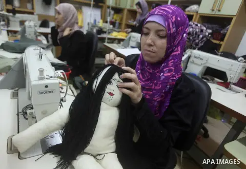 Deaf Palestinian women work on embroidery at Atfaluna Society for Deaf Children in Gaza City, on Aug. 26, 2012. The society provides services for about 15,000 deaf youth on education, training programs and income generat...