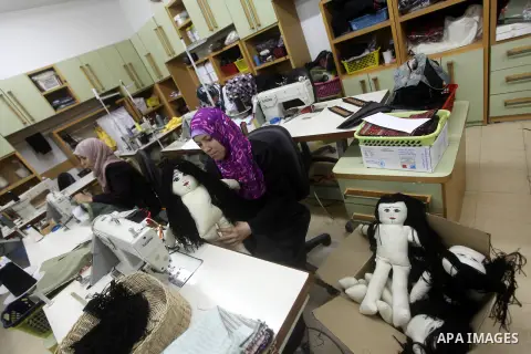 Deaf Palestinian women work on embroidery at Atfaluna Society for Deaf Children in Gaza City, on Aug. 26, 2012. The society provides services for about 15,000 deaf youth on education, training programs and income generat...