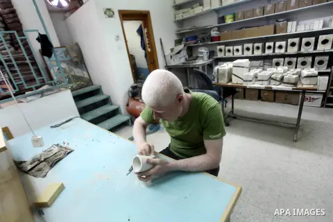 A Deaf Palestinian man works on porcelain drawing at Atfaluna Society for Deaf Children in Gaza City, on Aug. 26, 2012. The society provides services for about 15,000 deaf youth on education, training programs and income...
