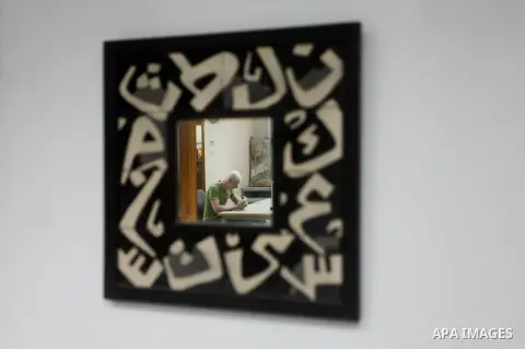 A Deaf Palestinian man works on porcelain drawing at Atfaluna Society for Deaf Children in Gaza City, on Aug. 26, 2012. The society provides services for about 15,000 deaf youth on education, training programs and income...