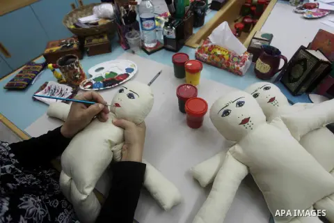 A Deaf Palestinian woman works on toys industry at Atfaluna Society for Deaf Children in Gaza City, on Aug. 26, 2012. The society provides services for about 15,000 deaf youth on education, training programs and income g...