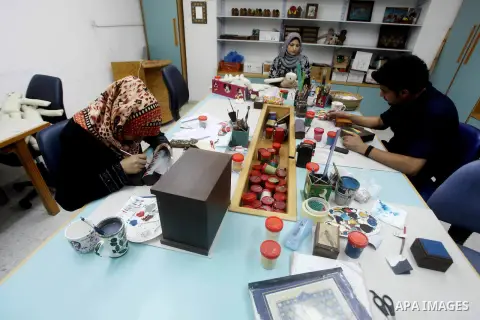 Deaf Palestinians work on porcelain drawing at Atfaluna Society for Deaf Children in Gaza City, on Aug. 26, 2012. The society provides services for about 15,000 deaf youth on education, training programs and income gener...