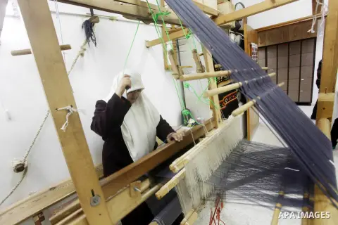 A Deaf Palestinian woman works on textile at Atfaluna Society for Deaf Children in Gaza City, on Aug. 26, 2012. The society provides services for about 15,000 deaf youth on education, training programs and income generat...