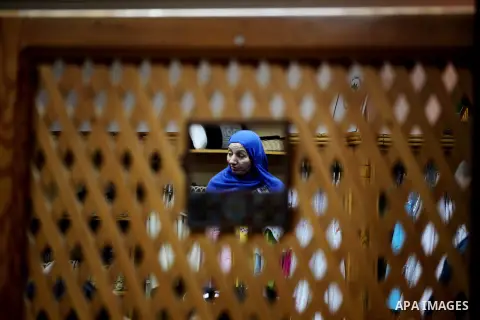 A Palestinian woman buys textiles at Atfaluna Society for Deaf Children in Gaza City, on Aug. 26, 2012. The society provides services for about 15,000 deaf youth on education, training programs and income generating proj...
