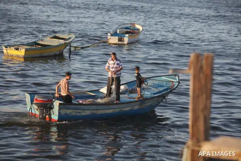 Palestinian fishermen work on their boats at the port of Gaza city on Aug 26, 2012. The ship Estelle, which leads the Freedom Flotilla will reach the Gaza port from San Sebastian, Basque Country, northern Spain within da...