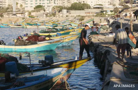 Palestinian fishermen work on their boats at the port of Gaza city on Aug 26, 2012. The ship Estelle, which leads the Freedom Flotilla will reach the Gaza port from San Sebastian, Basque Country, northern Spain within da...