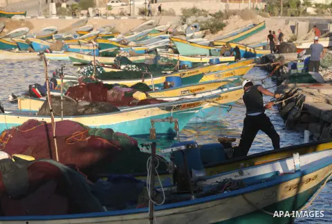 Palestinian fishermen work on their boats at the port of Gaza city on Aug 26, 2012. The ship Estelle, which leads the Freedom Flotilla will reach the Gaza port from San Sebastian, Basque Country, northern Spain within da...