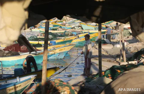 Palestinian fishermen work on their boats at the port of Gaza city on Aug 26, 2012. The ship Estelle, which leads the Freedom Flotilla will reach the Gaza port from San Sebastian, Basque Country, northern Spain within da...