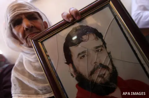 Palestinians hold pictures of their relatives prisoners in Israeli jails as they gather in an activity calling for their liberty at the Red Cross headquarters in Gaza City on Aug. 27, 2012. Photo by Majdi Fathi