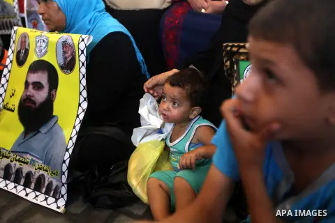 Palestinians hold pictures of their relatives prisoners in Israeli jails as they gather in an activity calling for their liberty at the Red Cross headquarters in Gaza City on Aug. 27, 2012. Photo by Majdi Fathi