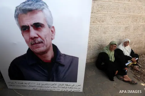 Palestinians hold pictures of their relatives prisoners in Israeli jails as they gather in an activity calling for their liberty at the Red Cross headquarters in Gaza City on Aug. 27, 2012. Photo by Majdi Fathi