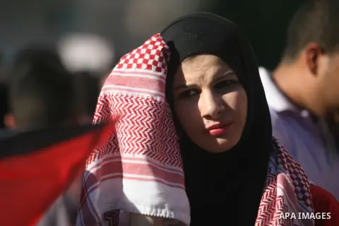 A Palestinian supporter of the Palestinian Front for the Liberation of Palestine (PFLP) waves a red flag during a rally mark the 11th anniversary of the assassination of PFLP leader Abu Ali Mustafa, in the West Bank city...