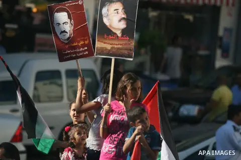 Palestinian children hold pictures of the PFLP leader Abu Ali Mustafa during a rally mark the 11th anniversary of assassinate him, in the West Bank city of Ramallah, on Aug 27, 2012. Photo by Issam Rimawi