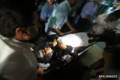 Nadia Salama Al-Rash, a wounded Palestinian women from al-Zeitoun neighborhood in Gaza city is wheeled into a hospital following an Israeli air strike on Aug 28, 2012. The Israeli air strike targeted al-Safina and Badr s...