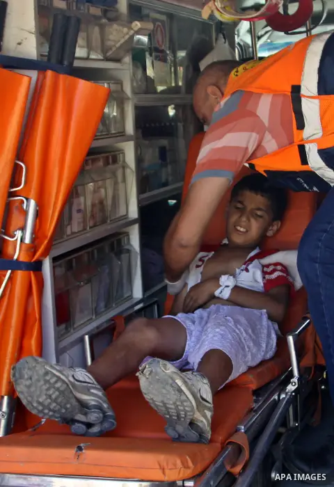 Palestinian medical workers carry wounded boy to an ambulance after Jewish settlers from the Israeli settlement of Livona attacked his familly house at Al - Loban Village near the west Bank City of Nablus on 28 August 20...