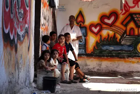 Palestinian children gather in an alley in Al-Shati refugee camp in Gaza City on August 28, 2012. Life in the poor and crowded Gaza Strip is going to get harsher still unless action is taken now, according to a new Unite...