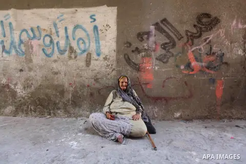 An elderly Palestinian woman sits on the ground outside her home at Al-Shati refugee camp in Gaza City on August 28, 2012. Life in the poor and crowded Gaza Strip is going to get harsher still unless action is taken now,...